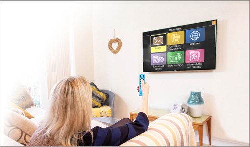 Woman using GuideConnect on a TV with the Dolphin Remote